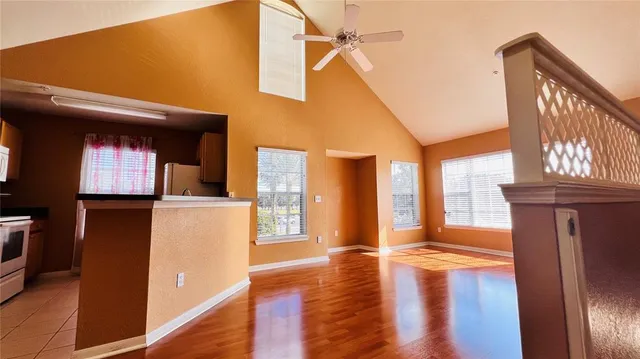 a kitchen with stainless steel appliances granite countertop a sink and a stove next to a window