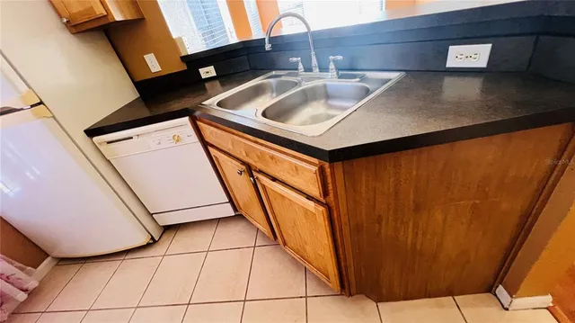 a bathroom with a granite countertop sink and toilet