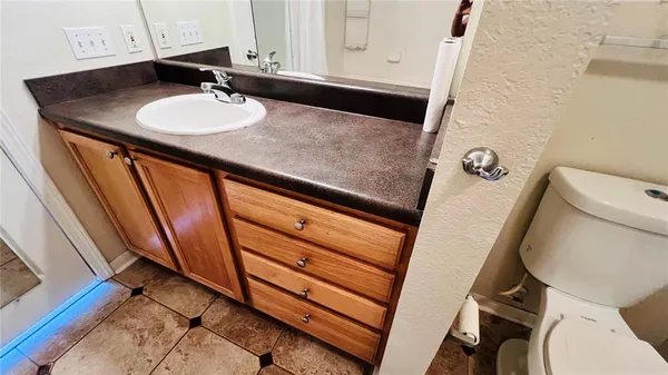 a white toilet sitting next to a bathroom sink