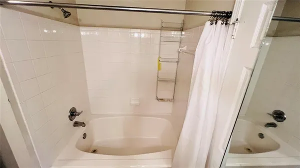 a view of a room with wooden floor and white walls