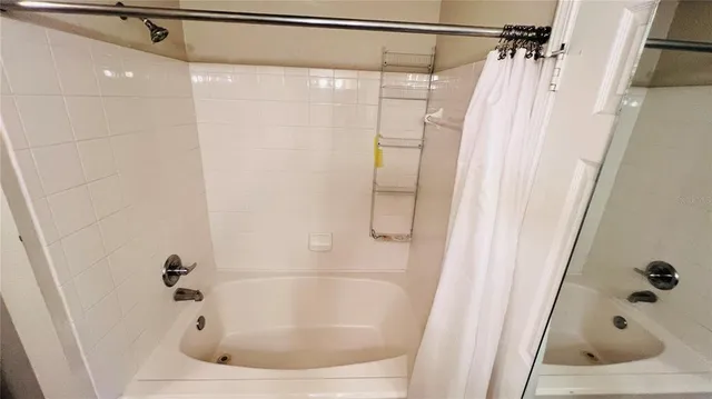 a view of a room with wooden floor and white walls