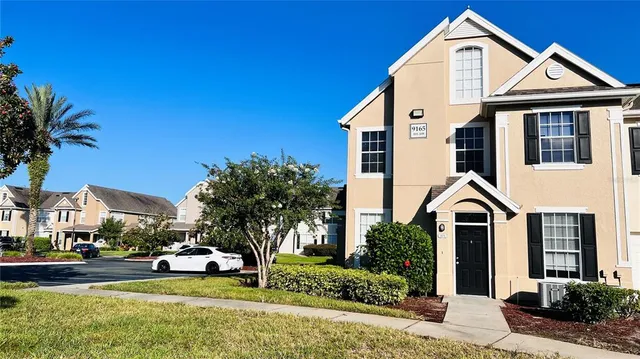 a view of an empty room with glass door and wooden floor