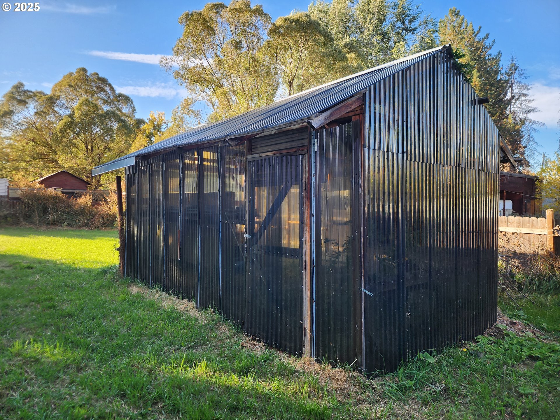 625 Baltimore Street Elgin, OR 97827 - Photo 12 of 17 a view of a backyard with potted plants and wooden fence