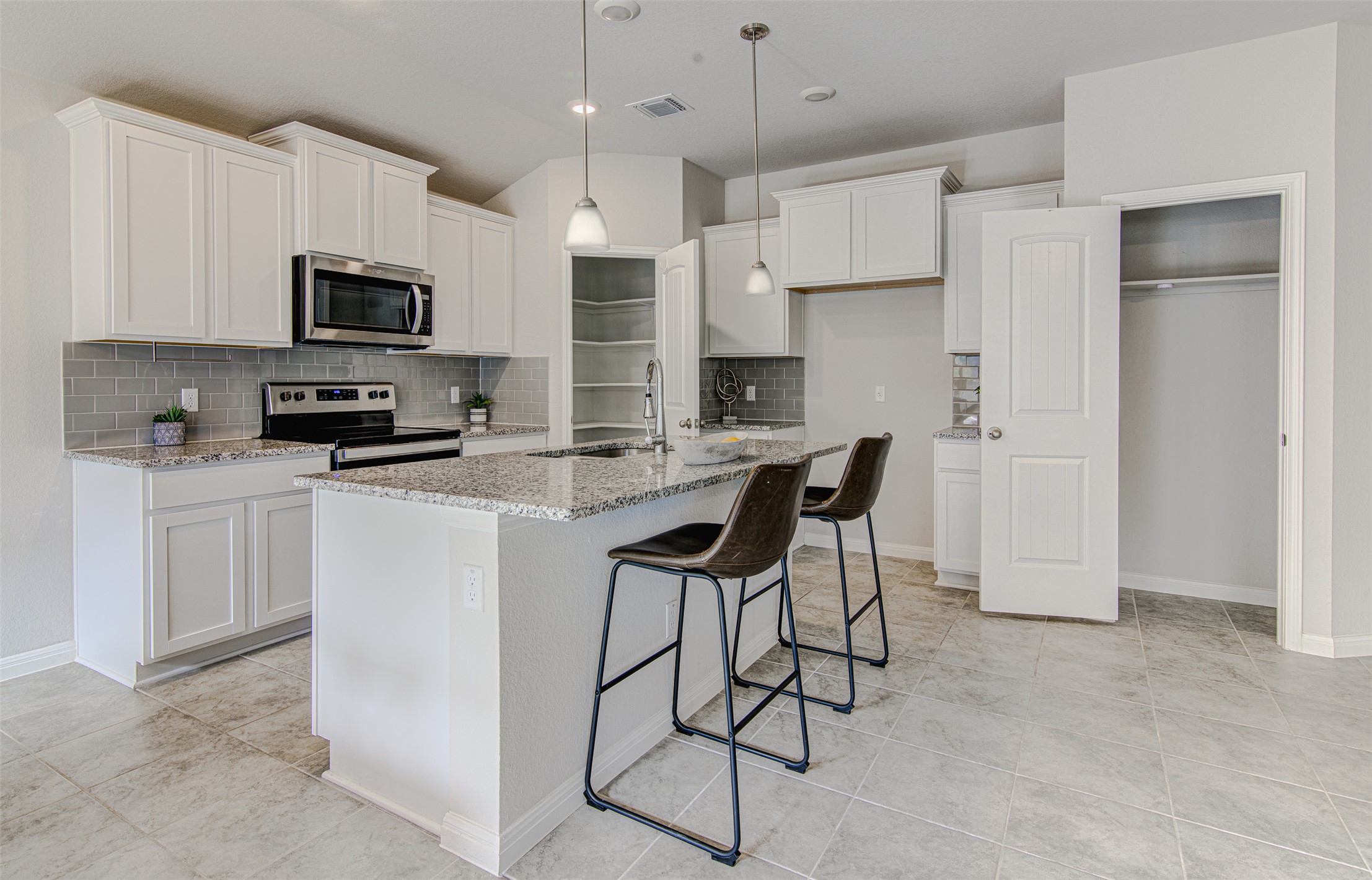 316 Pepper Mill Loop Burnet, TX 78611 - Photo 7 of 27 Granite counters and stainless steel appliances adorn this well-lit kitchen, ideal for culinary creations.