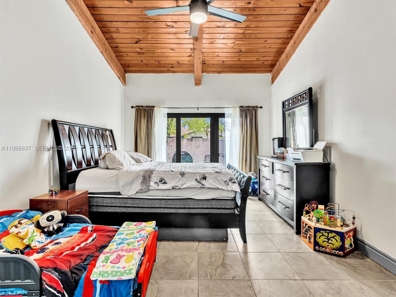 13406 Southwest 102nd Lane Miami, FL 33186 - Photo 22 of 47 a bedroom with furniture and a chandelier