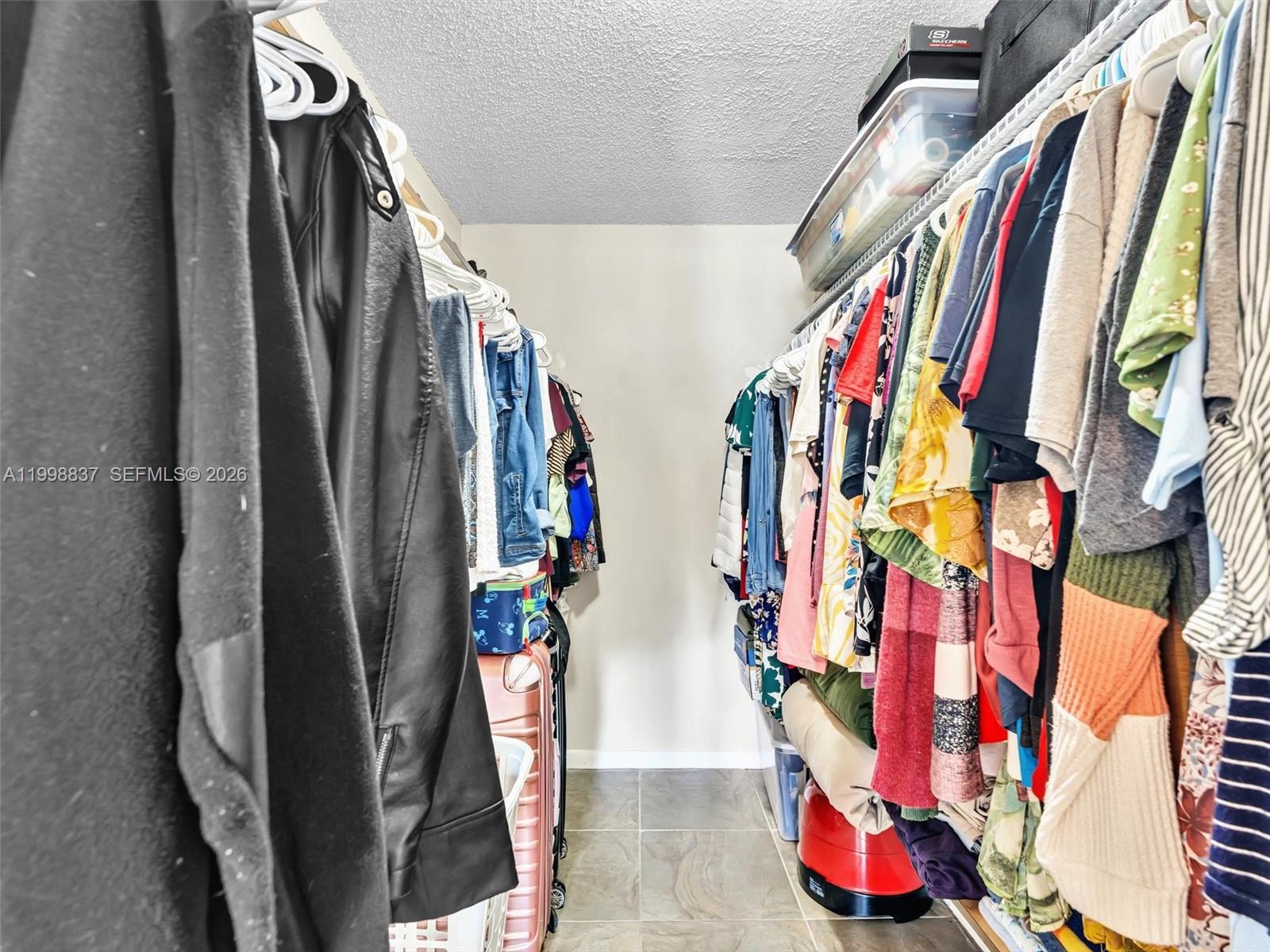 13406 Southwest 102nd Lane Miami, FL 33186 - Photo 24 of 47 a view of walk in closet with clothes and shoes