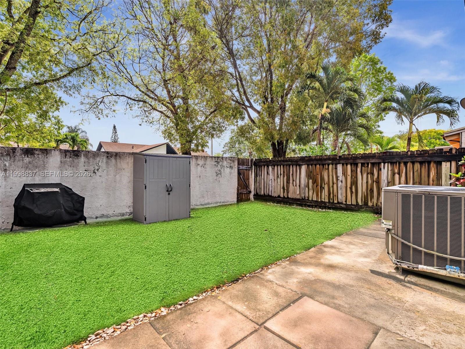 13406 Southwest 102nd Lane Miami, FL 33186 - Photo 36 of 47 a view of a backyard with potted plants and a large tree