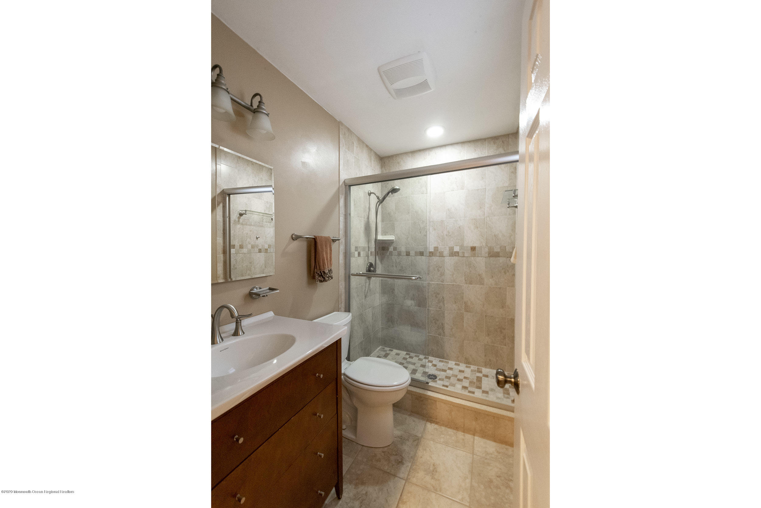 564 Nicholas Road Brick, NJ 08724 - Photo 16 of 22 a bathroom with a sink a toilet a shower and a mirror