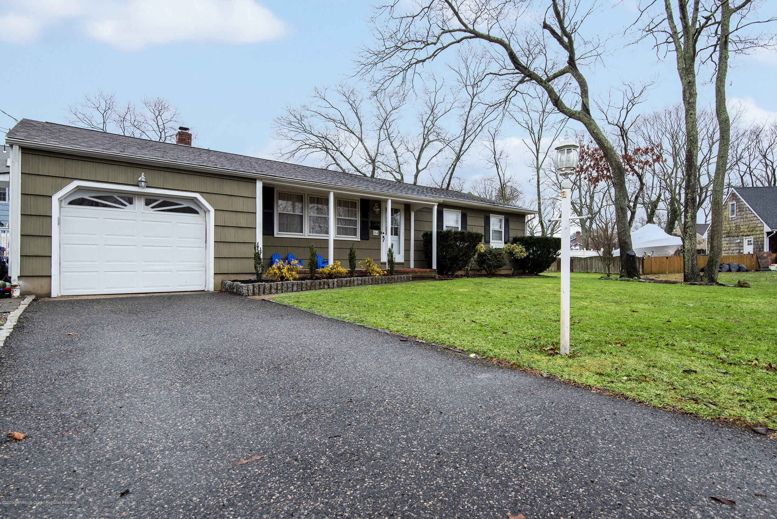564 Nicholas Road Brick, NJ 08724 - Photo 2 of 22 a view of a house with a small yard and large trees