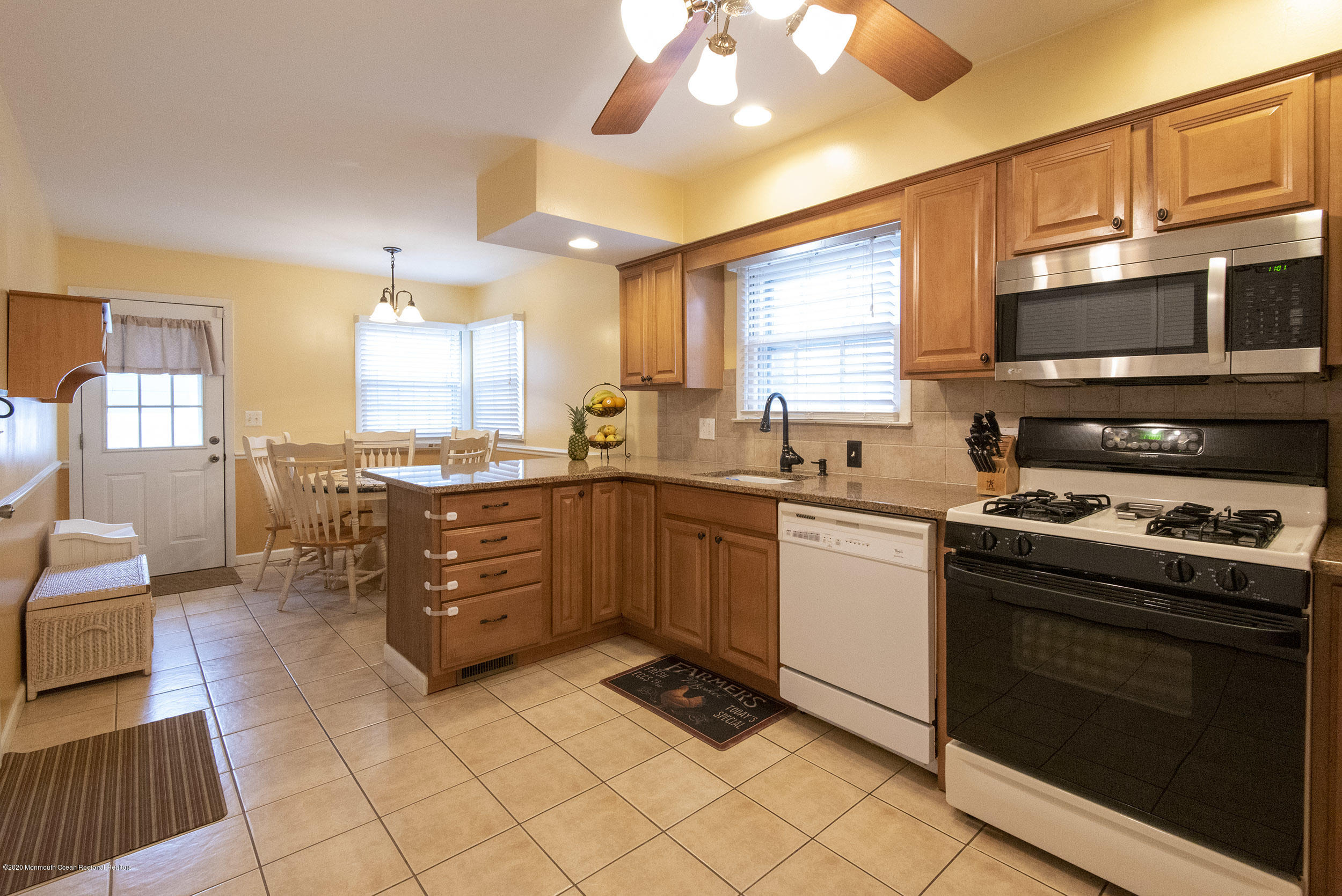 564 Nicholas Road Brick, NJ 08724 - Photo 8 of 22 a kitchen with stainless steel appliances granite countertop a stove a sink and a microwave