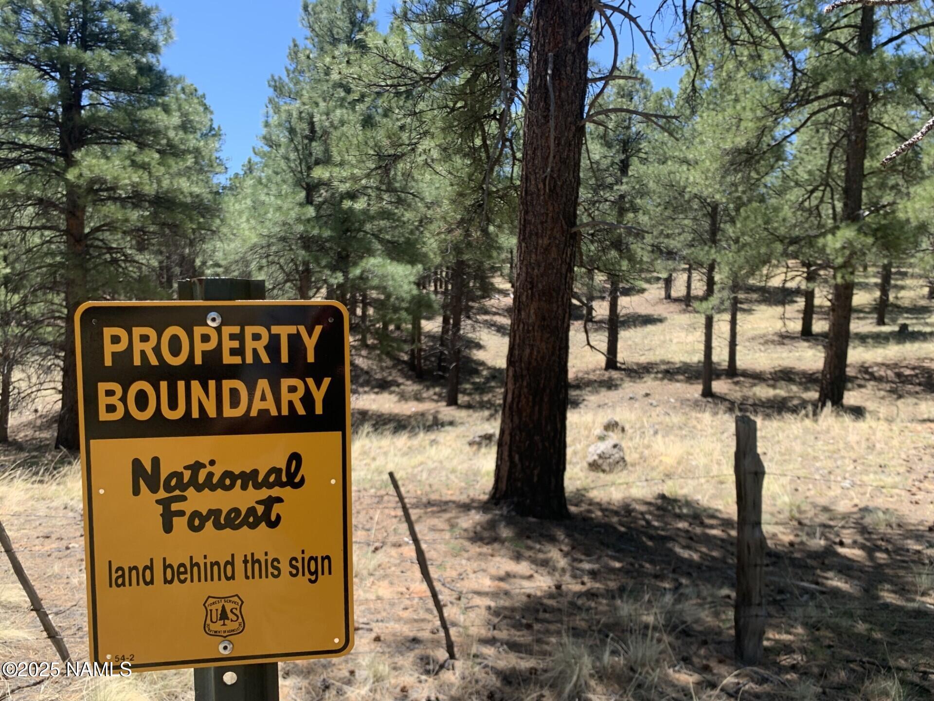 2343 East Del Rae Drive, Unit 176 Flagstaff, AZ 86005 - Photo 6 of 7 a sign broad on the side of the road