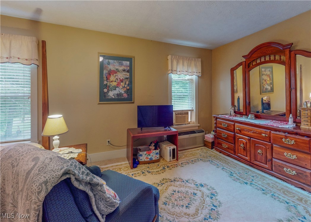 5696 Steubenville Road Southeast Amsterdam, OH 43903 - Photo 29 of 50 Bedroom featuring a textured ceiling and an AC wall unit
