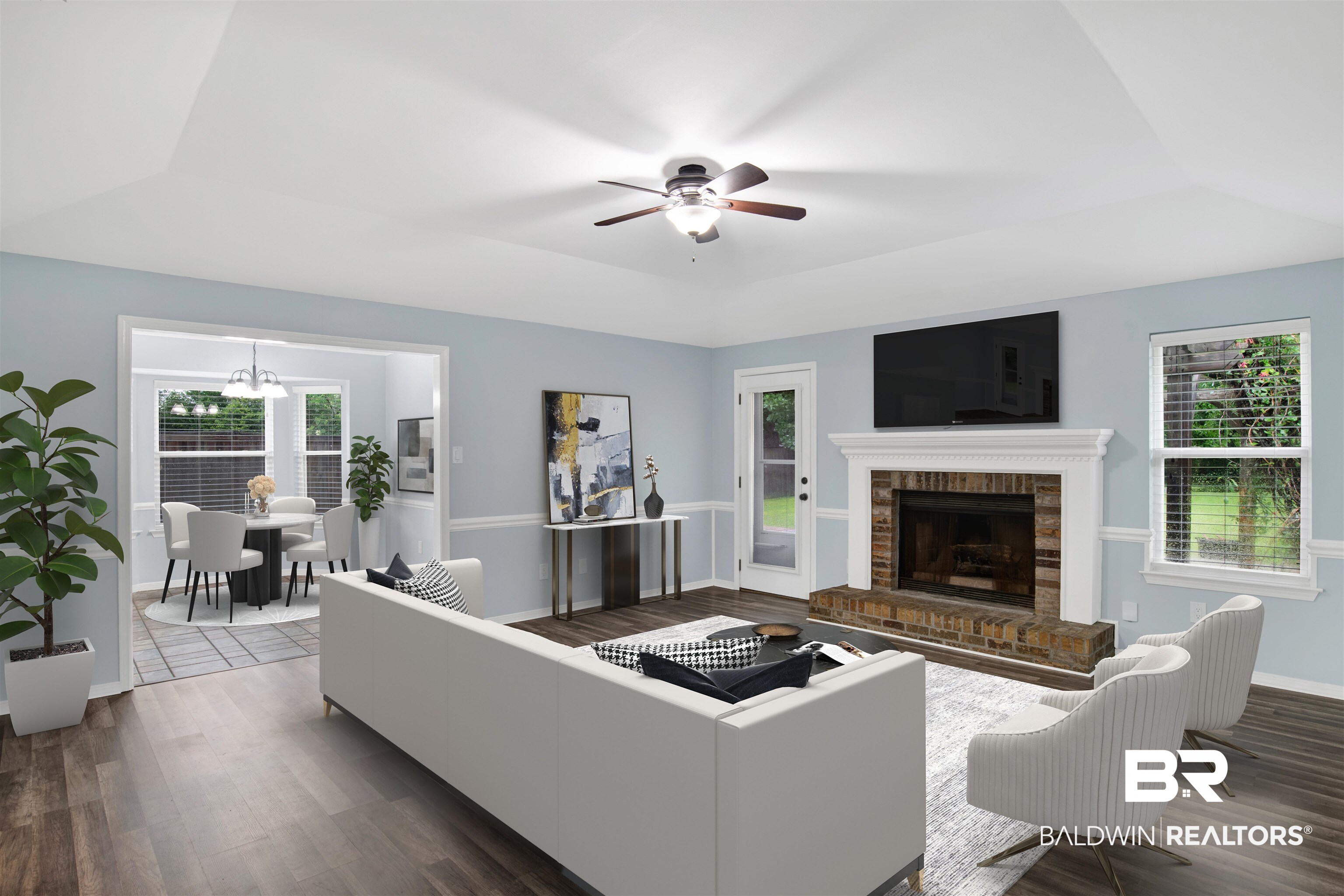 3011 Olde Gate Road Mobile, AL 36695 - Photo 7 of 35 Living area featuring a raised ceiling, a chandelier, wood finished floors, a ceiling fan, and a fireplace