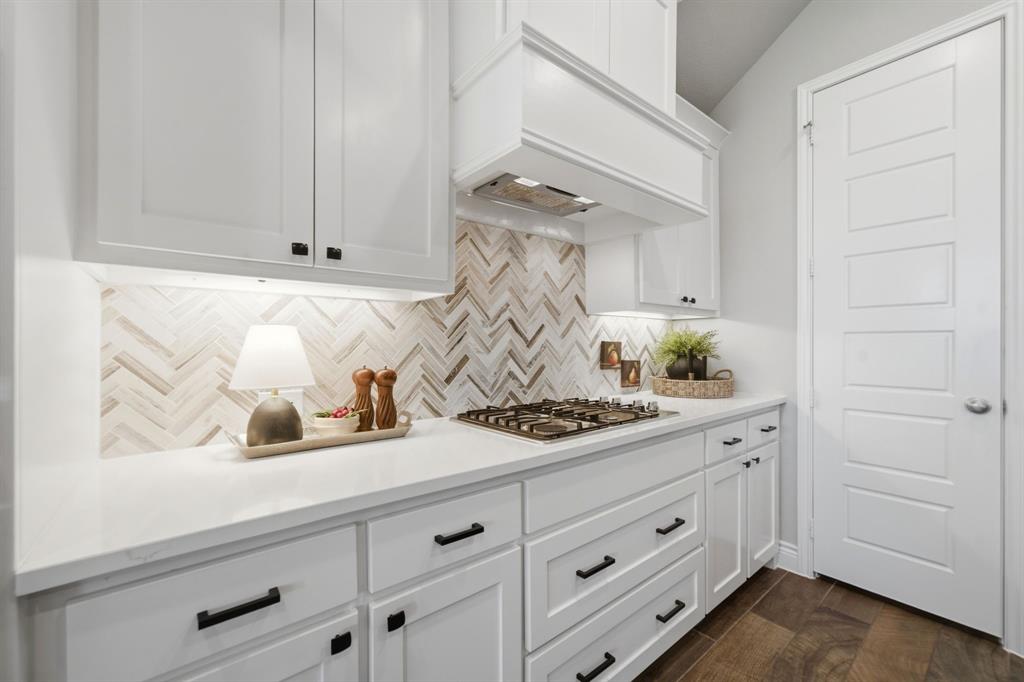 1121 Bantham Way Forney, TX 75126 - Photo 10 of 28 Gas cooktop with decorative backsplash.