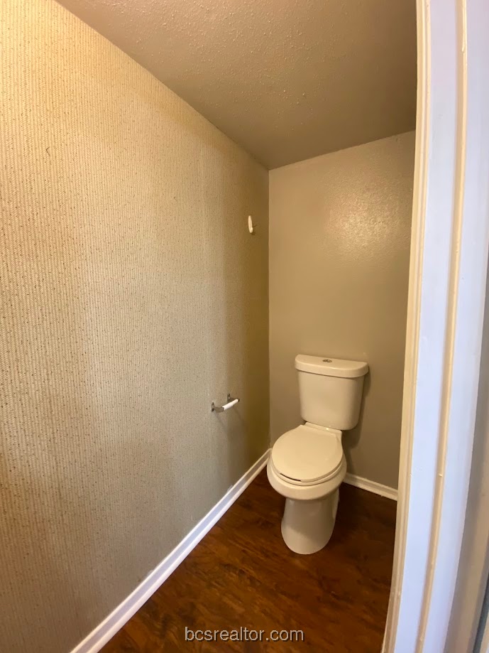 1305 West Villa Maria Road, Unit B106 Bryan, TX 77801 - Photo 5 of 14 a white toilet sitting in a bathroom and a sink