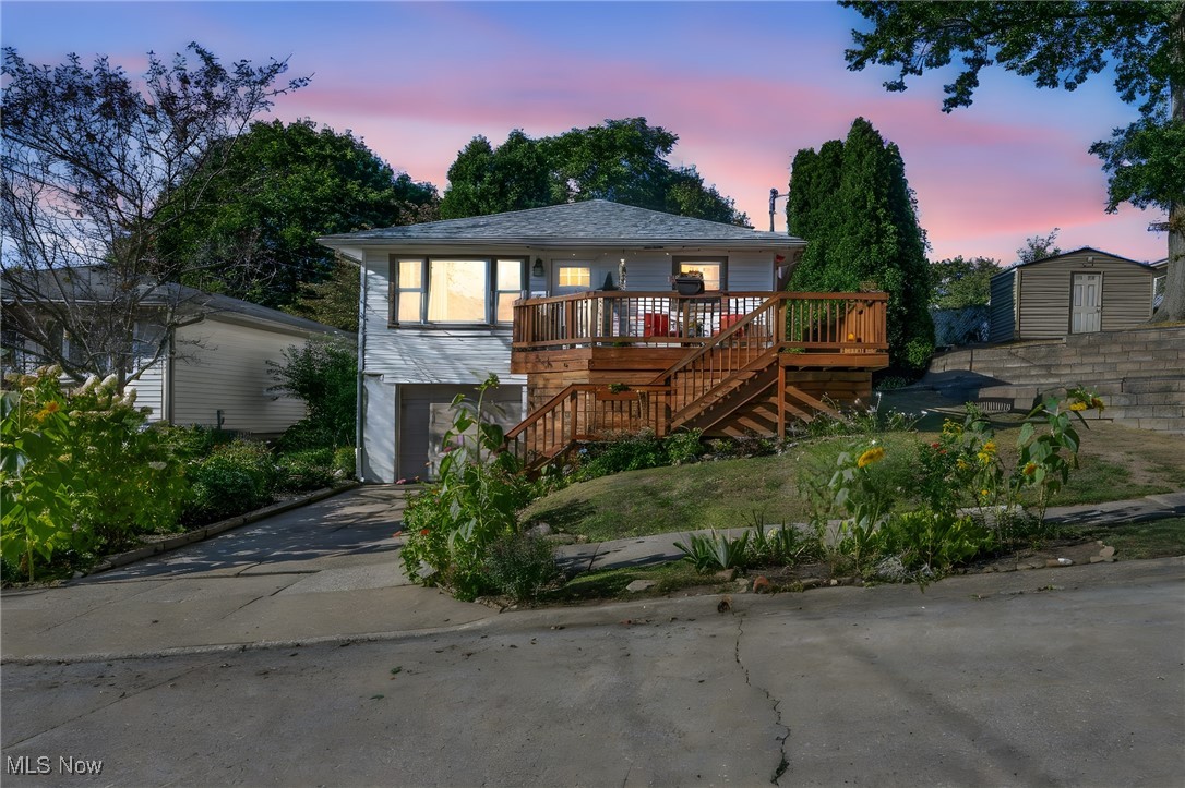 1641 Slusser Road Akron, OH 44305 - Photo 2 of 34 View of front of house with stairway, concrete driveway, a wooden deck, and a garage