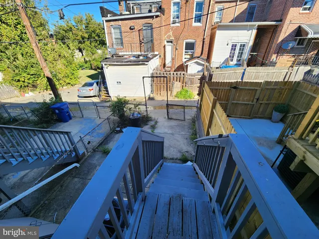 a view of balcony with two chairs and wooden fence