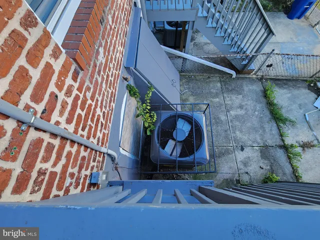 a wooden bench sitting in front of a building