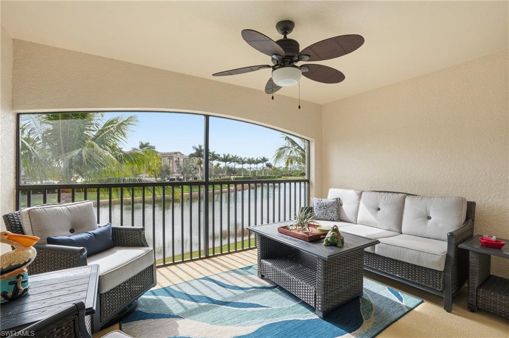 9528 Avellino Way, Unit 2521 Naples, FL 34113 - Photo 12 of 41 a living room with furniture and a large window