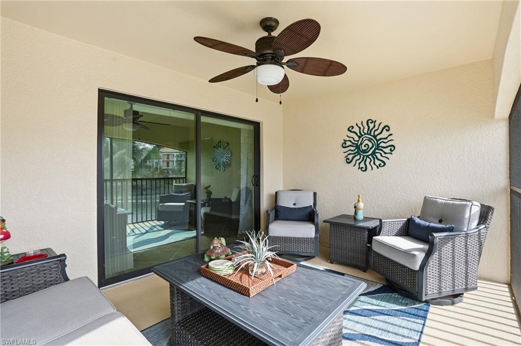 9528 Avellino Way, Unit 2521 Naples, FL 34113 - Photo 13 of 41 a living room with furniture and a window