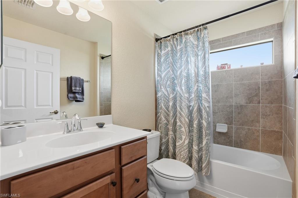 9528 Avellino Way, Unit 2521 Naples, FL 34113 - Photo 20 of 41 a bathroom with a sink a toilet and shower