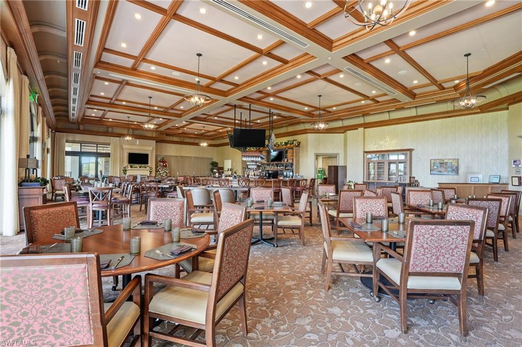 9528 Avellino Way, Unit 2521 Naples, FL 34113 - Photo 26 of 41 a view of a dining room with lots of wooden furniture