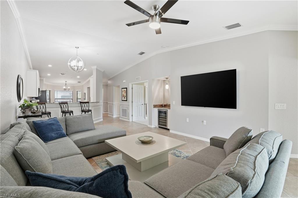 9528 Avellino Way, Unit 2521 Naples, FL 34113 - Photo 4 of 41 a living room with furniture and a flat screen tv