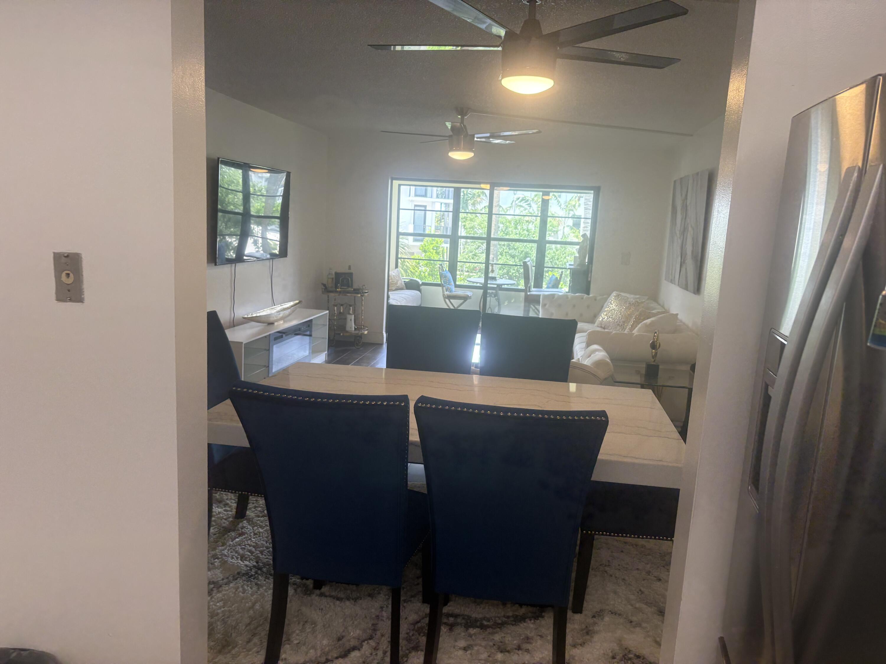9355 Southwest 8th Street, Unit 225 Boca Raton, FL 33428 - Photo 11 of 21 a view of a dining room with furniture and window
