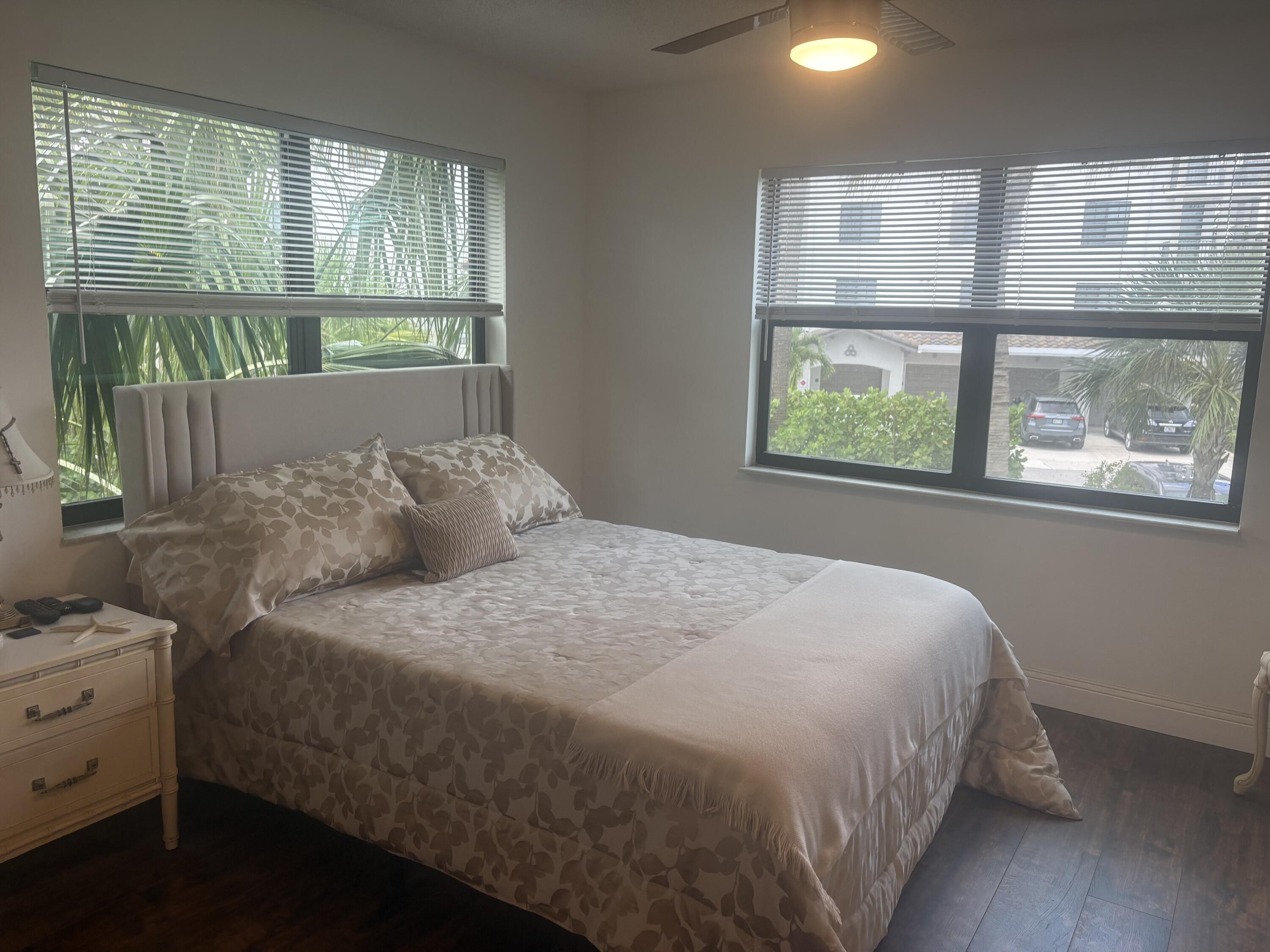 9355 Southwest 8th Street, Unit 225 Boca Raton, FL 33428 - Photo 12 of 21 a bed sitting in a bedroom next to a window