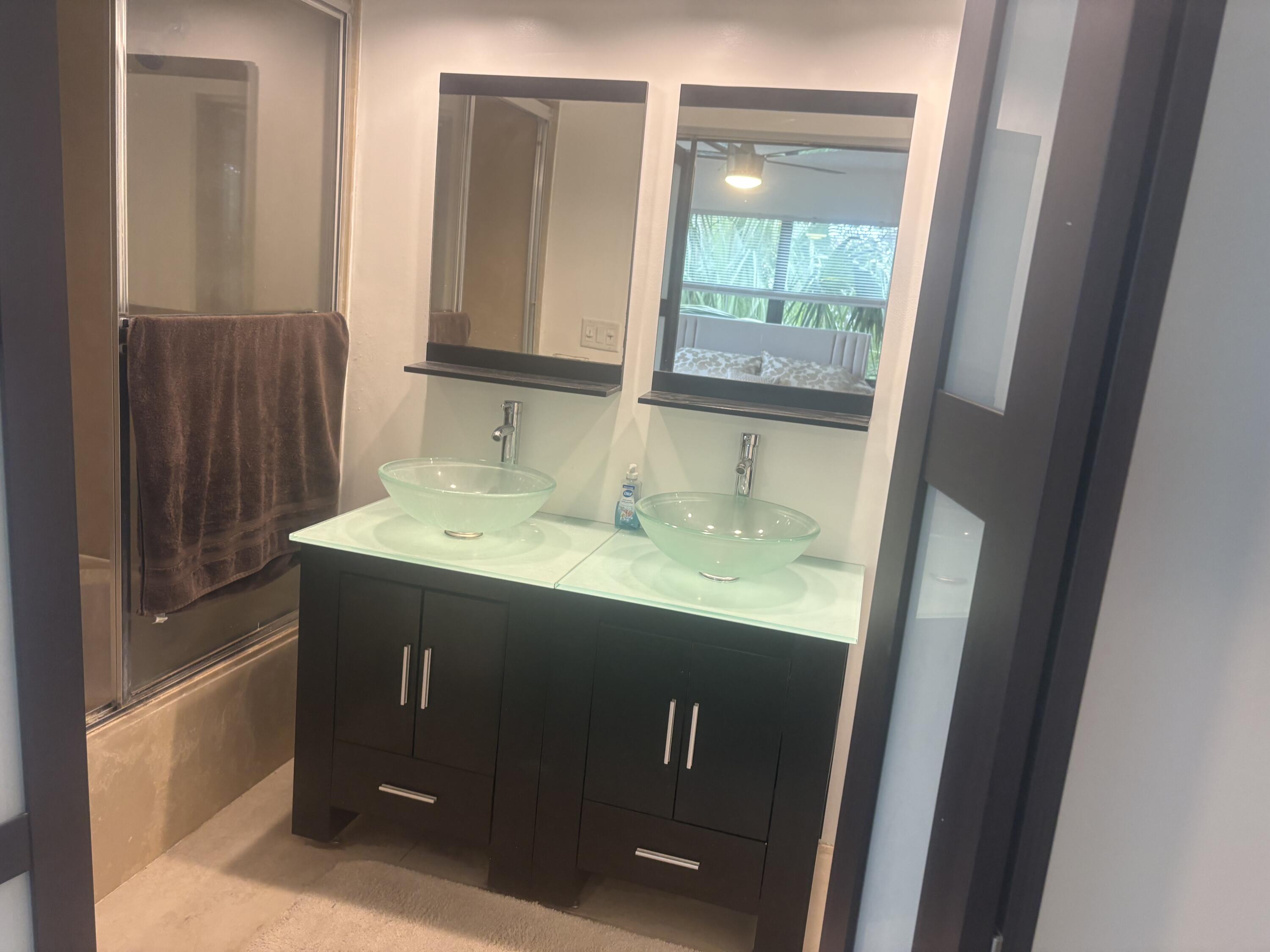 9355 Southwest 8th Street, Unit 225 Boca Raton, FL 33428 - Photo 13 of 21 a bathroom with a sink and a mirror