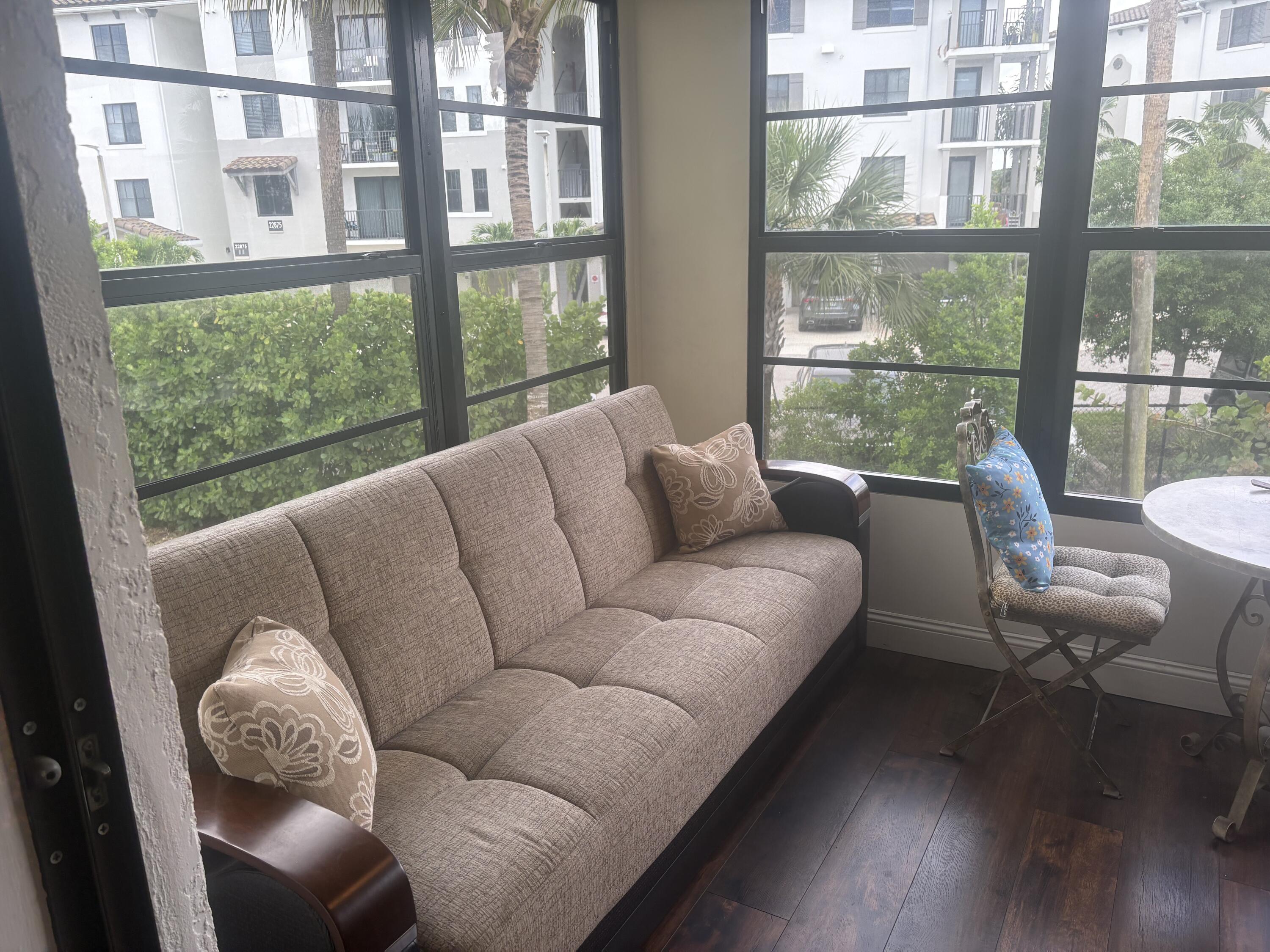 9355 Southwest 8th Street, Unit 225 Boca Raton, FL 33428 - Photo 16 of 21 a living room with furniture and a large window