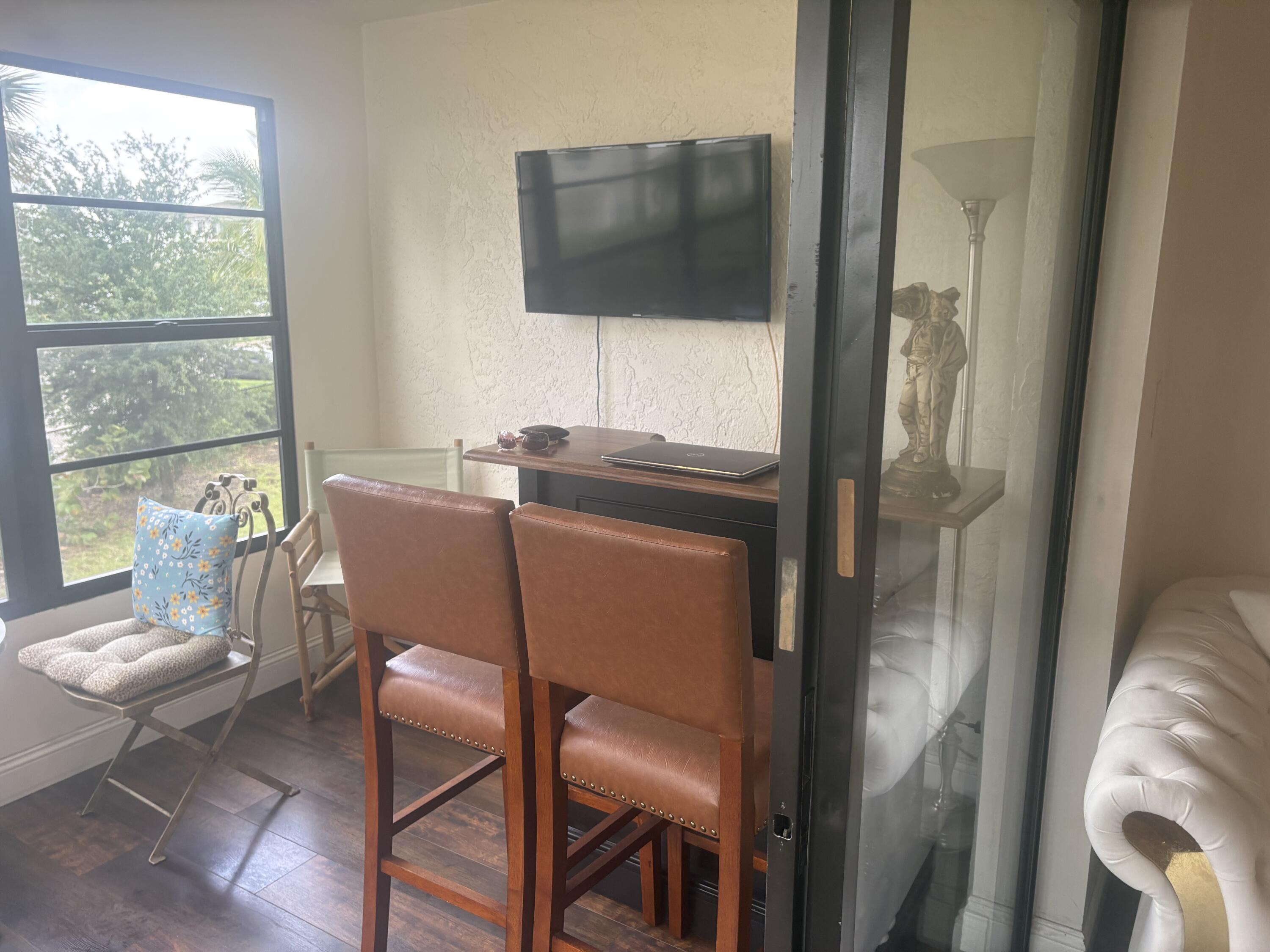 9355 Southwest 8th Street, Unit 225 Boca Raton, FL 33428 - Photo 17 of 21 a view of a dining room with furniture window and outside view