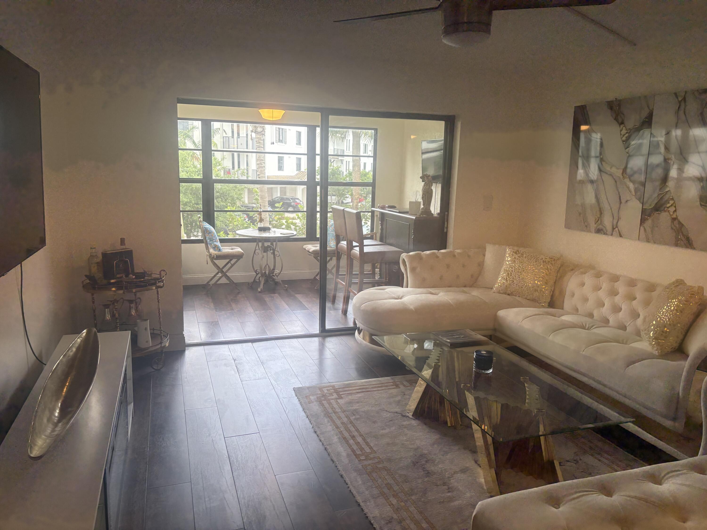 9355 Southwest 8th Street, Unit 225 Boca Raton, FL 33428 - Photo 3 of 21 a living room with furniture and a large window
