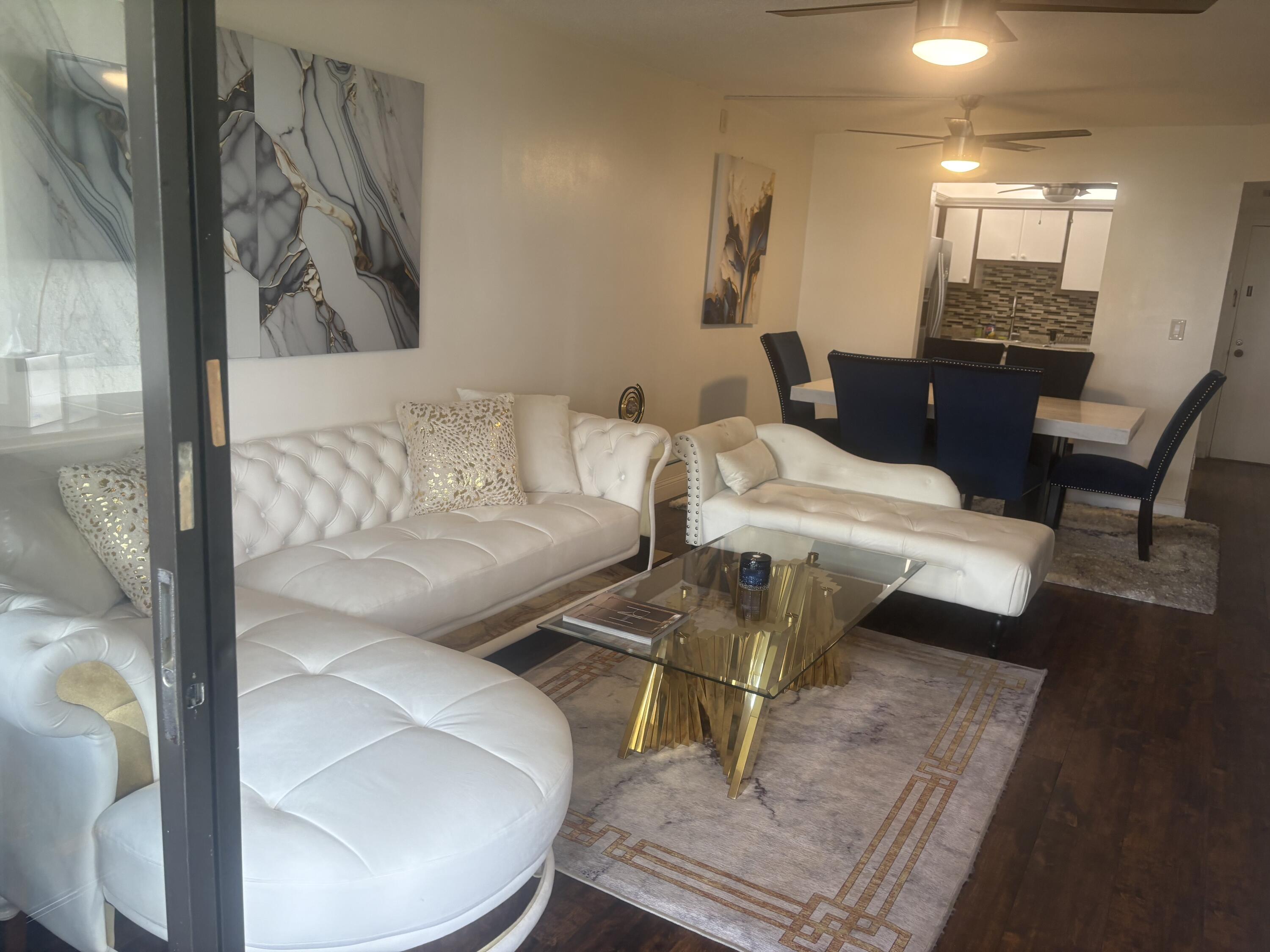 9355 Southwest 8th Street, Unit 225 Boca Raton, FL 33428 - Photo 5 of 21 a living room with furniture and wooden floor