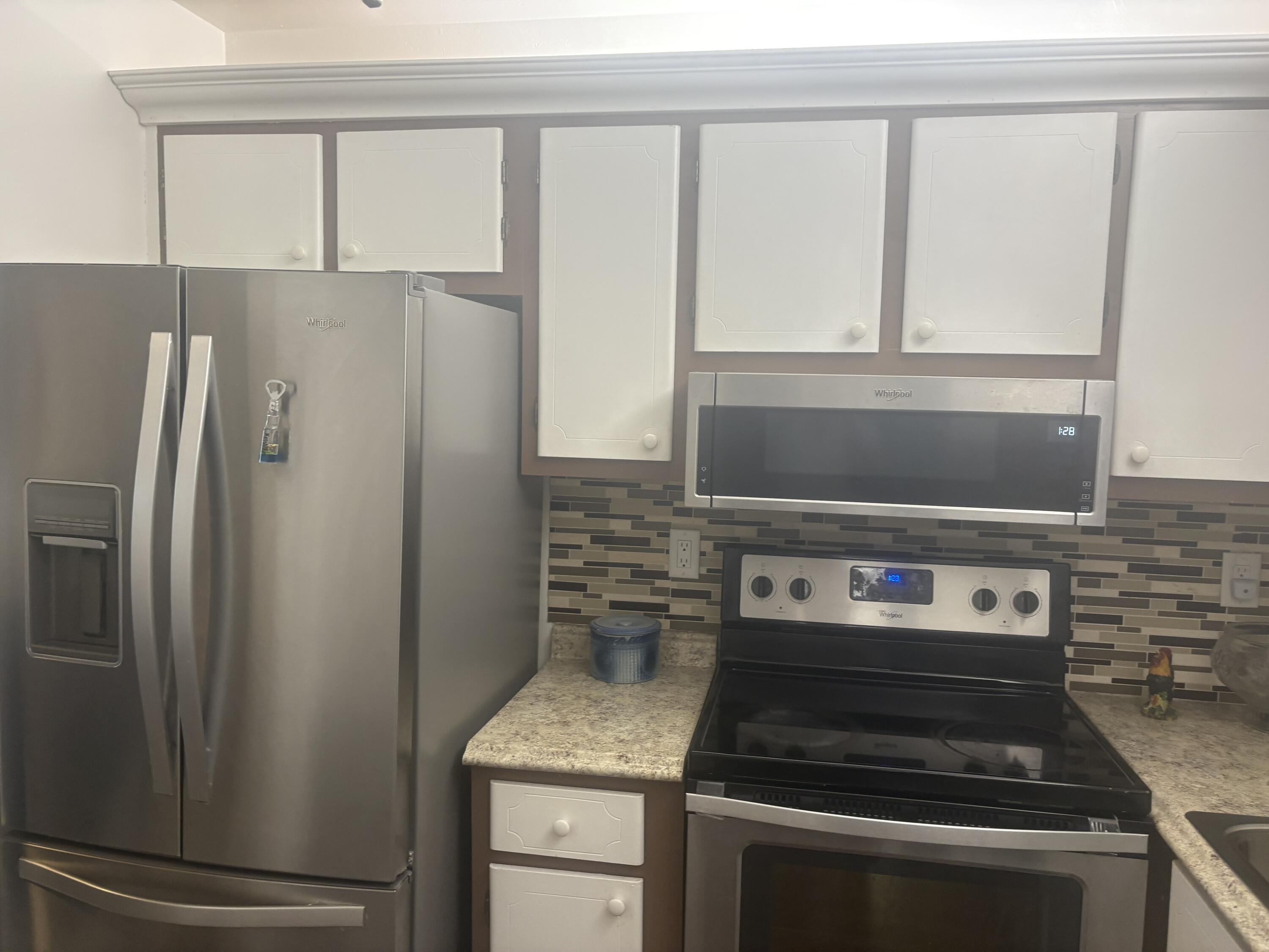 9355 Southwest 8th Street, Unit 225 Boca Raton, FL 33428 - Photo 6 of 21 a kitchen with a stove and a refrigerator