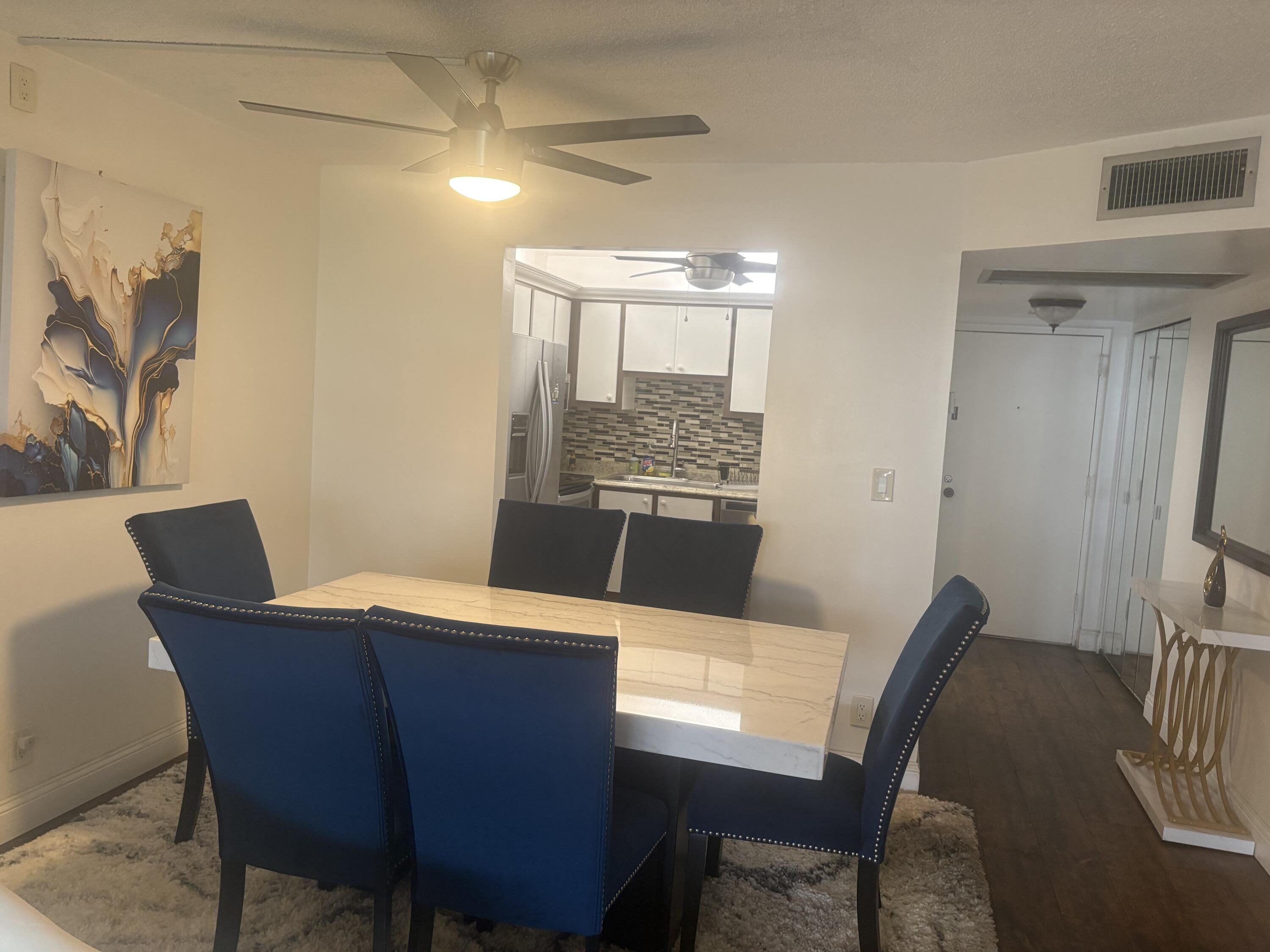 9355 Southwest 8th Street, Unit 225 Boca Raton, FL 33428 - Photo 9 of 21 a view of a dining room with furniture