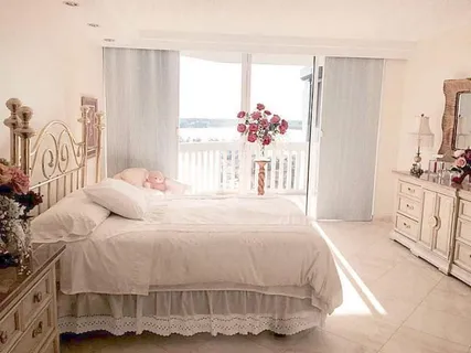 a bedroom with a bed and a large mirror