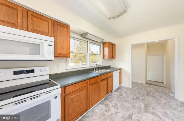 a kitchen with stainless steel appliances granite countertop a stove and a sink