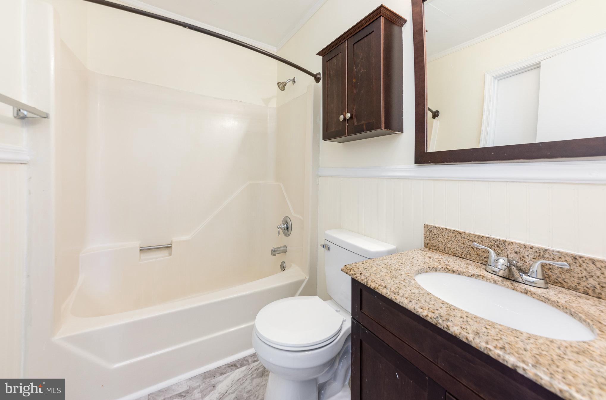 8430 Courthouse Road Spotsylvania, VA 22551 - Photo 15 of 23 a bathroom with a granite countertop sink toilet and shower