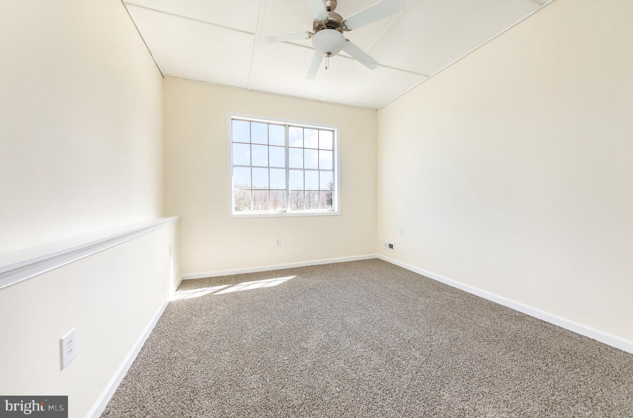 8430 Courthouse Road Spotsylvania, VA 22551 - Photo 8 of 23 an empty room with chandelier fan and windows