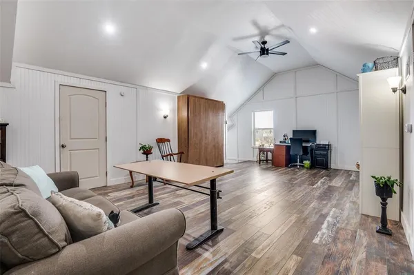 a living room with furniture and wooden floor