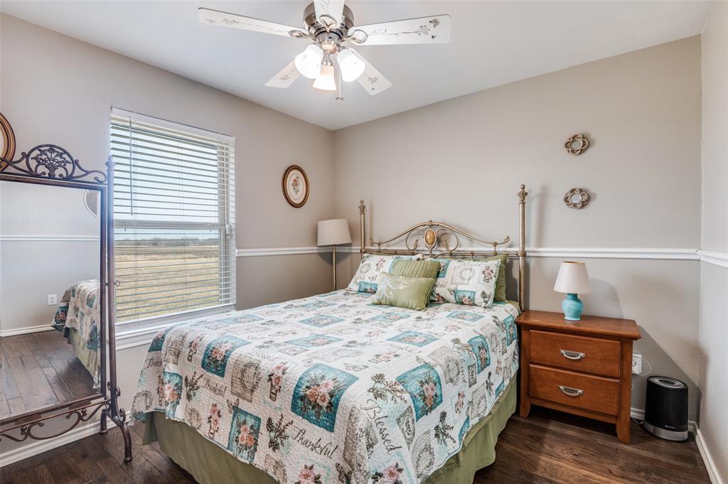 140 Hollis Road Waxahachie, TX 75167 - Photo 14 of 40 a bedroom with a bed and a chandelier