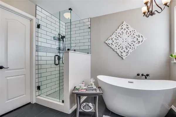a bathroom with a bathtub and shower