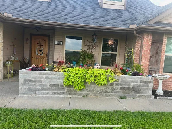 a front view of the house with potted plants