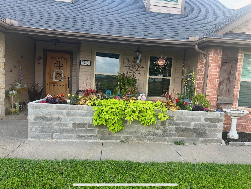 140 Hollis Road Waxahachie, TX 75167 - Photo 2 of 40 a front view of the house with potted plants