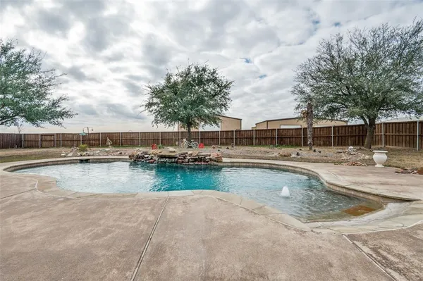 a view of swimming pool with outdoor seating and lake view