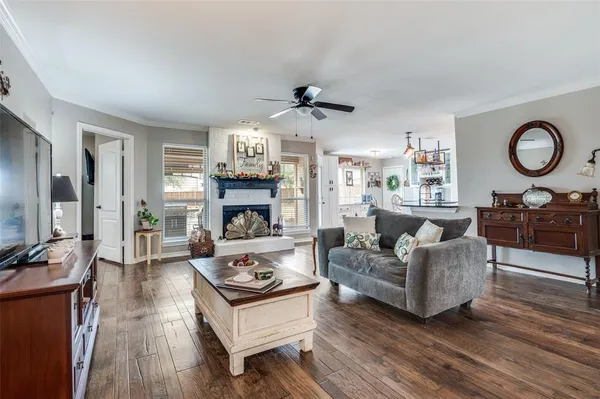 a living room with furniture a fireplace and a flat screen tv