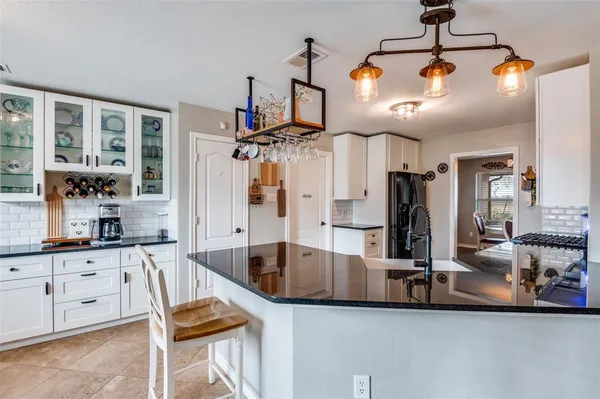 a kitchen with stainless steel appliances kitchen island granite countertop a sink and cabinets