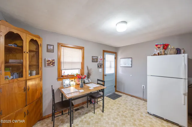 a living room with a couch and a refrigerator