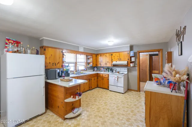 a kitchen with a refrigerator and a stove top oven